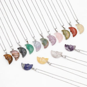 Various carved face moon pendants made of natural crystal stones on silver chains