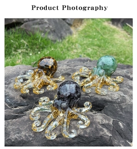 Octopus figurines with natural amethyst and gold foil inside on outdoor rock