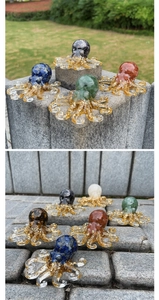Macro detail of octopus resin statue with crystal gravel and gold foil accents