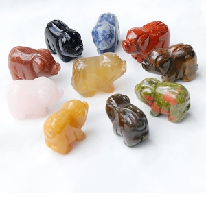 Macro shot of 1-inch mini pig figurines carved from assorted natural healing crystals