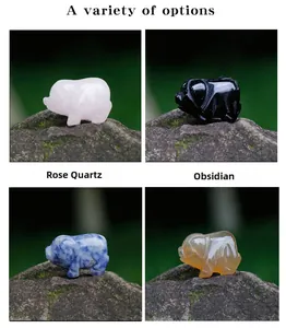 Detail of hand-carved mini pig figurines in natural rose quartz and obsidian stones