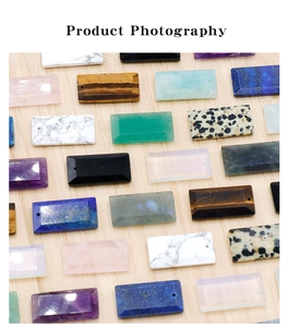 Flat lay of rectangular faceted natural stone pendants on a light wood background