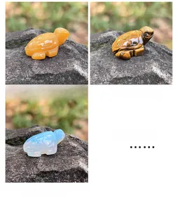 Macro shot of hand-carved sea turtle figurines in tiger eye, yellow jade, and opalite stone