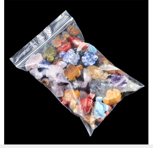 Macro shot of assorted natural crystal turtle carvings in a clear protective pouch