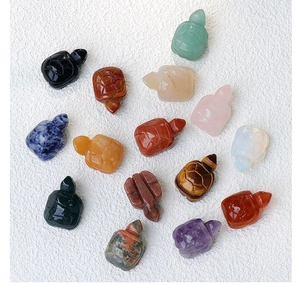 Detailed view of hand-carved turtle figurines made from various natural healing crystals
