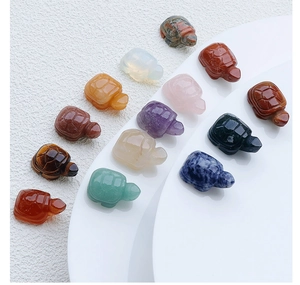 Detailed macro shot of diverse hand-carved crystal and gemstone turtle figurines