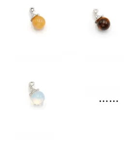 Detailed view of crystal spheres in yellow jade, tiger eye, and opalite with silver caps