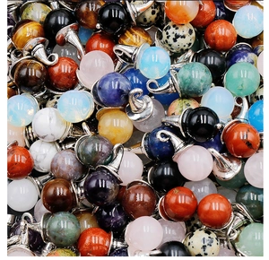 Macro shot of assorted colorful round crystal pendants with silver metal bails