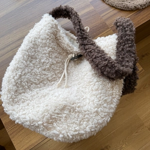 Detailed top view of plush fleece tote bag with brown contrast straps and drawstring closure