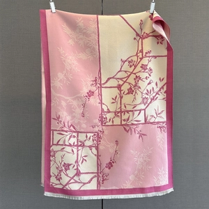 Detail of pink floral cashmere shawl featuring vintage patterns and soft white tassels