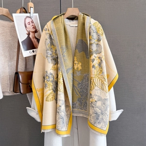 Close-up of floral cashmere scarf with fringe tassels and yellow botanical patterns