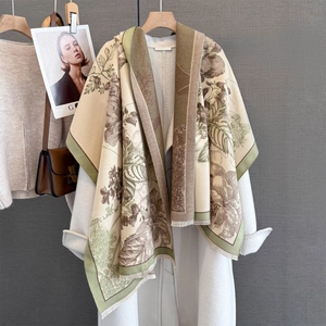 Elegant floral cashmere-feel scarf with fringes styled over a white autumn coat