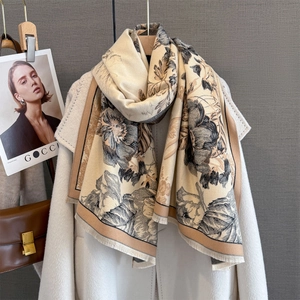 Detail of elegant large floral jacquard pattern and tassel edges on thick warm shawl