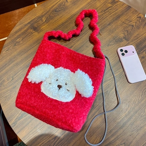 Detail of red plush tote bag showing soft lamb wool texture and cute white puppy patch