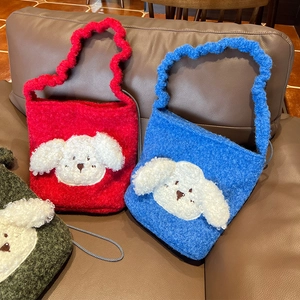 Detail view of plush drawstring tote bags in red and blue with cute 3D puppy ornaments
