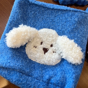 Close-up of bright blue teddy plush tote bag featuring a cute white fluffy puppy decor