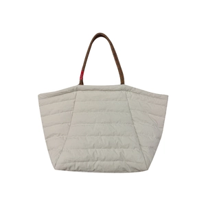 Light grey quilted cloud tote bag with brown handles and spacious puffer design