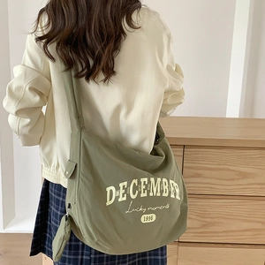 Sac bandoulière en nylon vert olive avec imprimé Lucky Moments en situation réelle