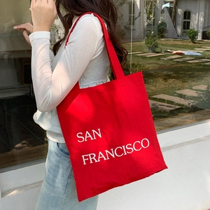 Detailed texture of red nylon tote bag with white San Francisco letter printing