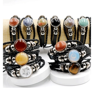 Detailed collection of woven leather bracelets featuring various natural gemstone inlays