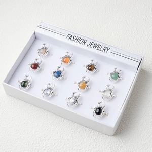Set of 12 punk spider rings featuring various pear-cut colorful stones in a display box