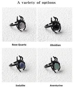 Detailed view of punk spider rings set with rose quartz, obsidian, and aventurine stones