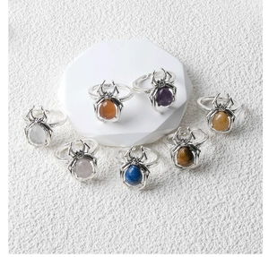 Detailed close-up of punk spider rings featuring various colorful crystal stone inlays