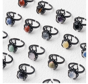 Detail of adjustable spider rings with varied natural gemstone inlays and black plating