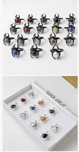 Detailed view of punk spider rings with natural crystal and agate gemstones in various colors