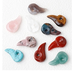 Collection of carved natural stone bird skull pendants in assorted crystals and gemstones