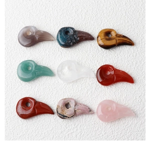 Macro shot of 9 assorted natural stone bird skull pendants for DIY jewelry making