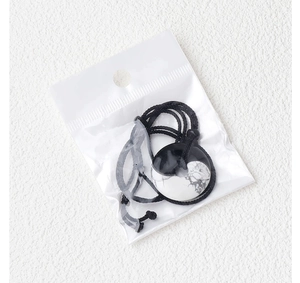 Close-up of Tai Chi Yin Yang pendant necklace with stone texture in a simple package
