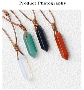 Macro detail of assorted hexagonal crystal point pendants on braided rope necklaces
