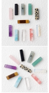 Macro view of polished rectangular natural amethyst and crystal stone column pendants