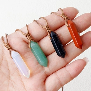 Natural crystal double point hexagonal prism pendants with handmade woven ropes on palm