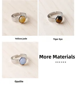 Detail view of yellow jade, tiger eye, and opalite stones set in silver rings