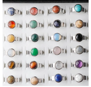Macro view of 24 natural stone rings in various gemstones set in stainless steel bands