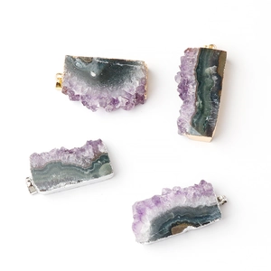 Irregular raw amethyst cluster pendants with gold and silver metal edges on white background