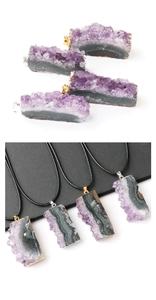Macro detail of natural amethyst geode pendant with electroplated gold edge and black cord