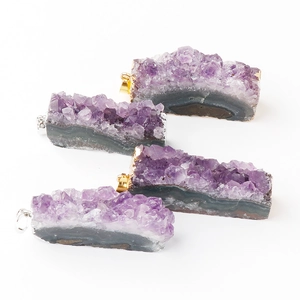 Natural amethyst cluster slice pendants with gold and silver plated edges on white background