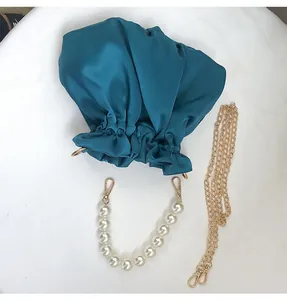 Peacock blue satin cloud bag with pearl handle and gold chain detail view