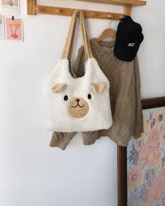 Detail of cute plush teddy bear tote bag showing soft sherpa texture and shoulder straps