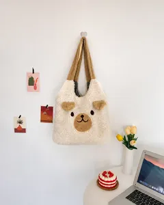 Detail of plush bear tote bag featuring 3D ears and black-white checkered lining