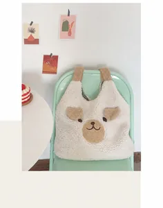 Detail of cute bear tote bag showing soft sherpa texture and checkered lining fabric