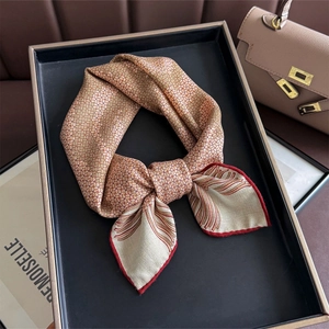 Silk wool square scarf with rose print and golden micro-check pattern on a tray