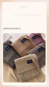 Detailed close-up of plaid scarf fringe and Elegant & Classic woven label textures
