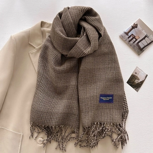 Thick brown checkered cashmere scarf with tassels styled on a beige suit blazer