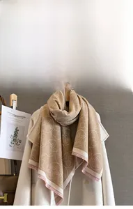 Détail d'une écharpe douce au toucher cachemire avec jacquard floral et franges roses