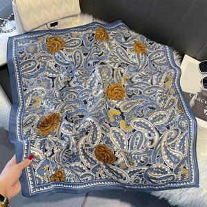 Vintage paisley print square scarf with floral pattern on white faux fur background