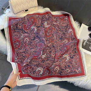 Close-up of vintage paisley print silk scarf in retro red and navy blue tones